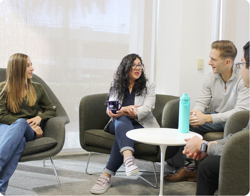 OCTA team members smiling in employee lounge