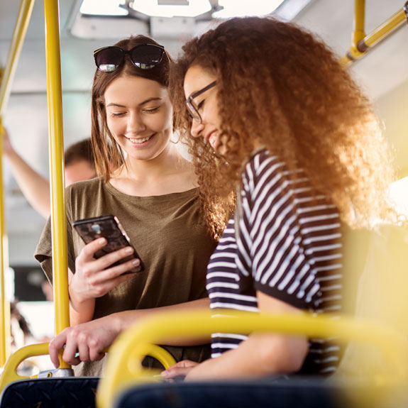 2 Students riding on the bus