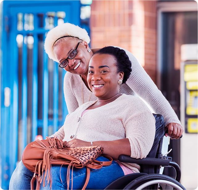 A mother helps her daughter in a wheelchair